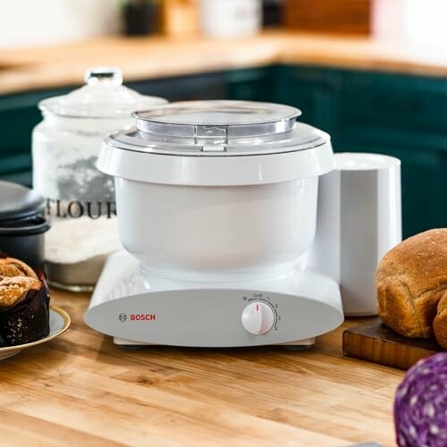 A close-up of the mixer's attachments, including the wire whips and dough hook, showcasing its range of features.