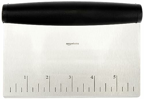 Metal dough scraper with measurements.