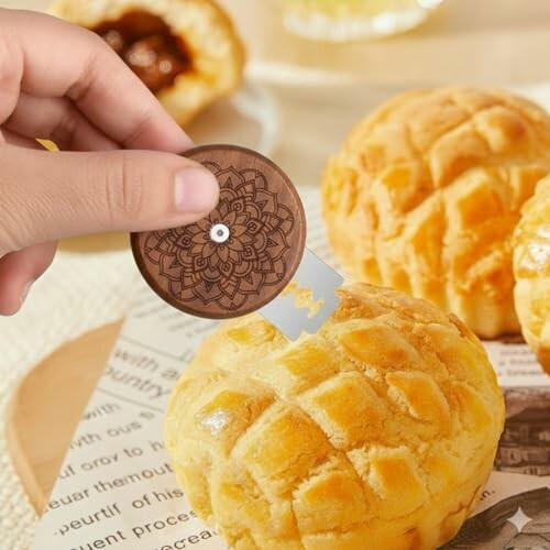Person using a small knife on pineapple buns.