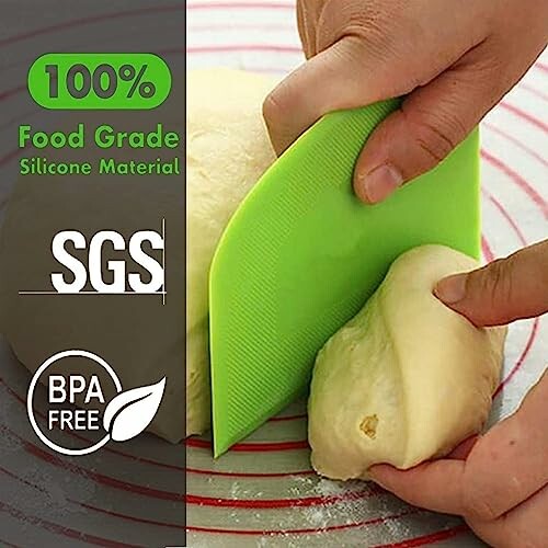 Person using green silicone dough scraper on dough