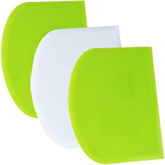 Three silicone paste scrapers in green and white.
