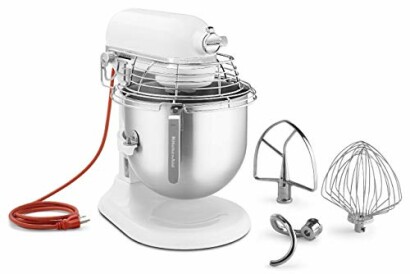 White stand mixer with wire guard, mixing bowl, and attachments.