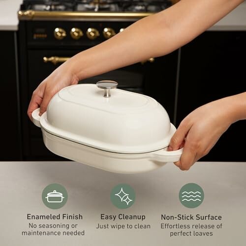 Hands holding a white bread baker in a kitchen with stove in background.